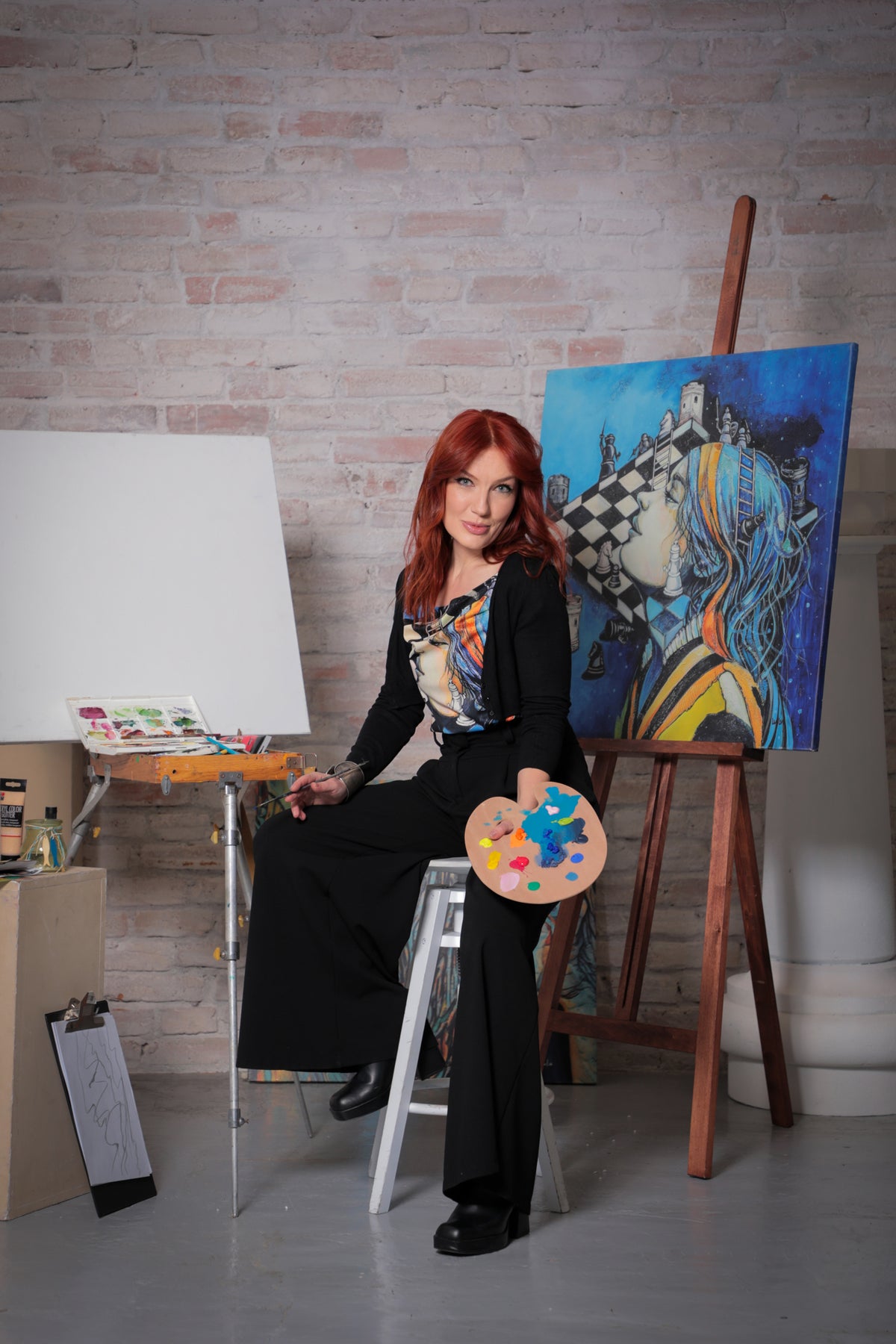 Lulu in her atelier with an original painting